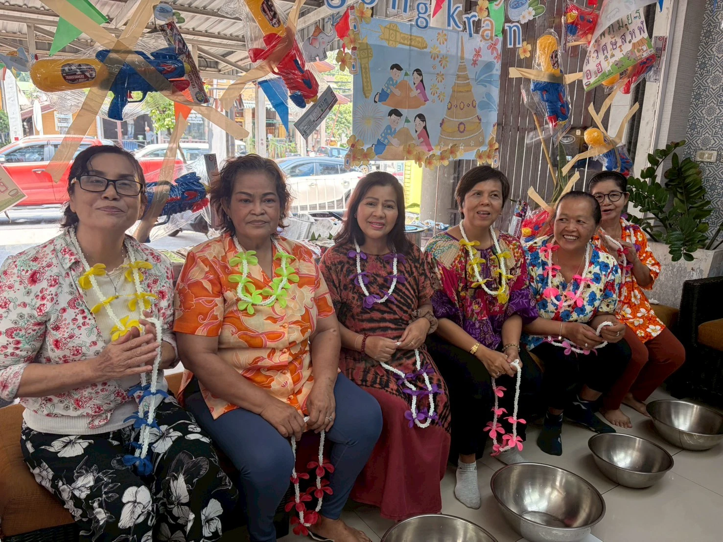 The Genius Language School - teachers holding flower garlands
