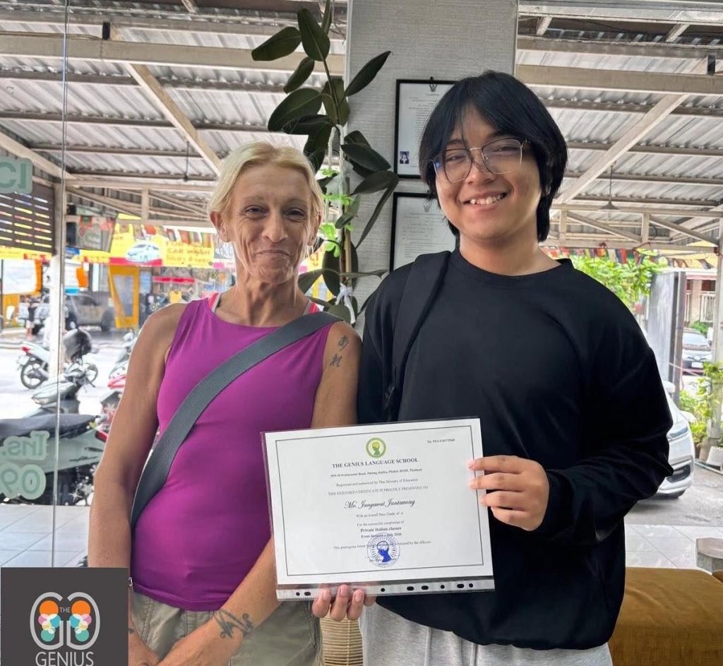 The Genius Language School - August - A student with his certificate posing with a head or teacher