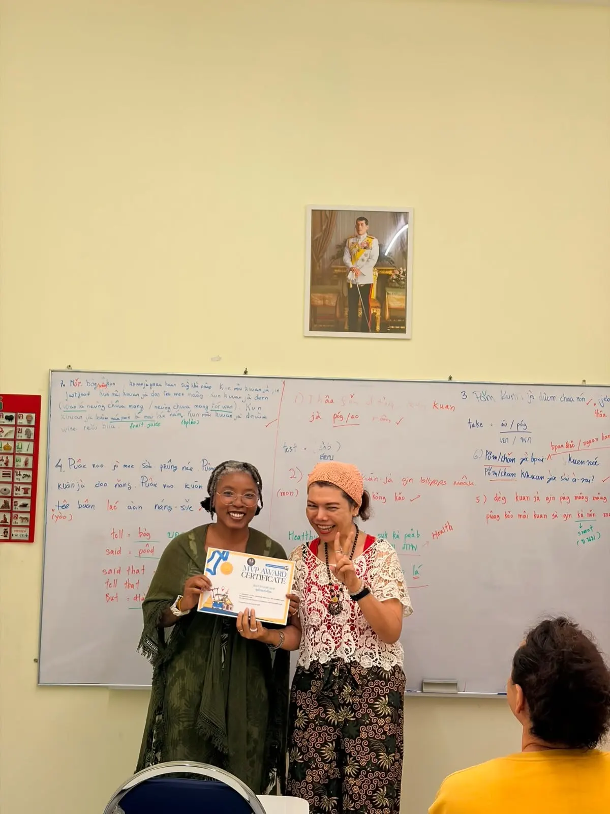 Teacher handing language training completion certificate - Genius Language School 6