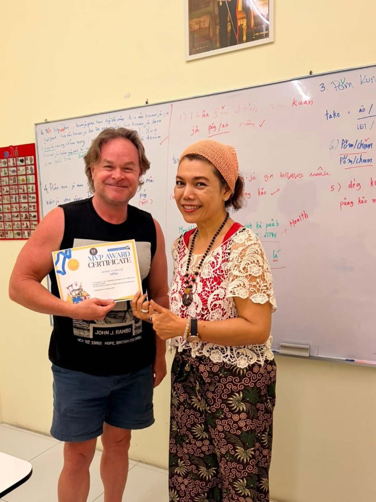 Teacher handing language training completion certificate